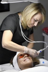 Jmore beauty expert Ariel Lewis receives a HydraFacial treatment from Sarah Schneider, an aesthetician at Studio of Make-Up & Skin Health in Owings Mills.