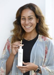 Jmore beauty expert Ariel Lewis drinks a Skinade skincare supplement after a HydraFacial treatment.